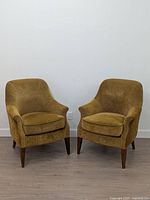Front view of both armchairs showing upholstery and legs