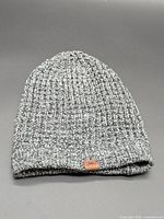 Top view of the Roots grey knit beanie showing texture and logo patch