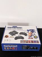 Retail box top showing Sega Genesis Classic Game Console, controllers, Sonic graphic, 81 games badge
