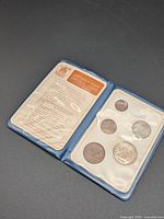 Closed presentation wallet showing informational insert and coins