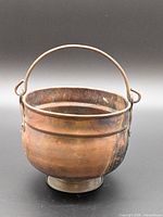 Front view of copper pot showing overall shape and handle