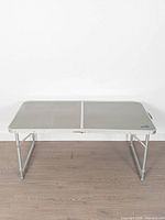 Full view of rectangular folding table standing on its legs