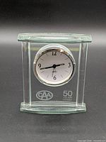 Front view showing glass frame, clock face, and etching