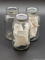 Three clear glass Bernardin 1 L mason jars with metal lids