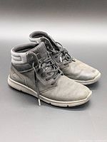 Side view of both sneakers showing overall style and condition