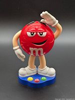 Front view of Red M&M’s figurine on base
