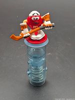 Front view of red M&M hockey player dispenser