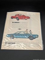 Full view of sleeved magazine advertisement featuring red 1966 Corvette and blue Corvair