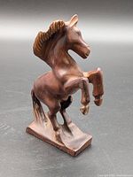 Front-left view of wooden rearing horse figurine