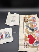All three cross-stitch pieces displayed