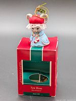 Front view of mouse bell ornament on box
