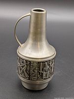 Full view of pewter jug showing shape, handle and relief band