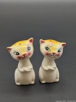 Front view of both ceramic cat shakers
