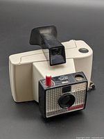 Angled front view of Polaroid Swinger Model 20 camera