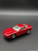 Passenger front three-quarter view of red Corvette model car