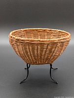 Side view of woven basket on metal stand
