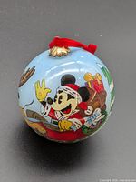 Full view of ornament showing Mickey Mouse on sleigh scene