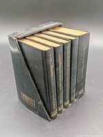 Five black pocket reference books in slipcase