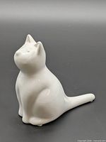3/4 side view of white ceramic cat figurine