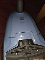 Top view of light-blue Kenmore 200 Series AllergenSeal canister vacuum body showing logo and hose connection