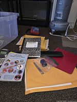 Overall contents: label maker, mailers, envelopes, notebook, folder, calculator, tote, tokens, pen, strip