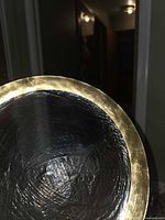 Close-up of charger plate showing textured glass center and gold rim