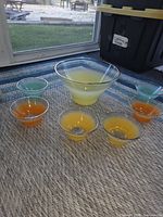 Full set displayed: large bowl center, six small bowls around