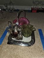 Group shot showing green hobnail dish, cranberry basket, art glass bowl and silver frame