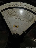 Close view of Toledo scale dial showing brand and graduations