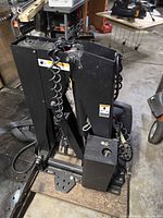 Full view of folded hydraulic lift showing frame, pump unit and wiring