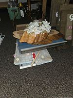 Pile showing wooden plaques, slabs, faux-flower slab, easel stand and additional decorated planks