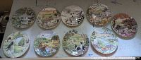 Full set of ten decorative plates laid out on table
