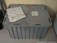 Top view of grease interceptor showing lid, paperwork, labels