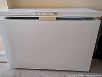 Closed front view of Woods chest freezer