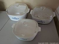 All three Corning Ware Blue Cornflower casseroles with lids displayed