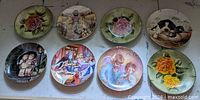 All eight decorative plates visible on flat surface