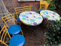 Full view of both tables and several chairs showing overall style and colours