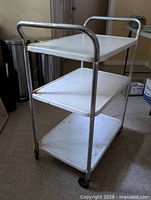 Front angle of three-tier cart showing shelves and frame