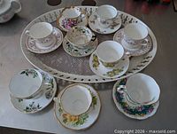 Top view showing all eight teacup and saucer pairs on tray