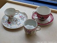 Group view of three teacups and two saucers