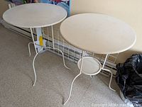 both round metal side tables side-by-side