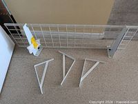 Wire shelf panel with three separate brackets laid out