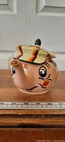 Front view of Wade Andy Capp teapot showing striped cap lid and spout as nose