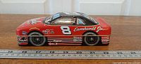 Left side view of the race car tin with ruler showing length