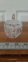 Front view of apple-shaped crystal dish with ruler showing diameter ~2.75 in