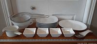 Group shot of all 16 kitchenware pieces lined up on table