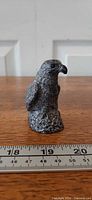 Front view of Wolf Original eagle figurine with ruler showing height