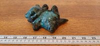 Top view of drip-glazed cat figurine next to ruler