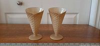 Front view of both waffle cone glasses on wooden surface