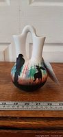 Full view of vase front with moose silhouette, ruler for scale